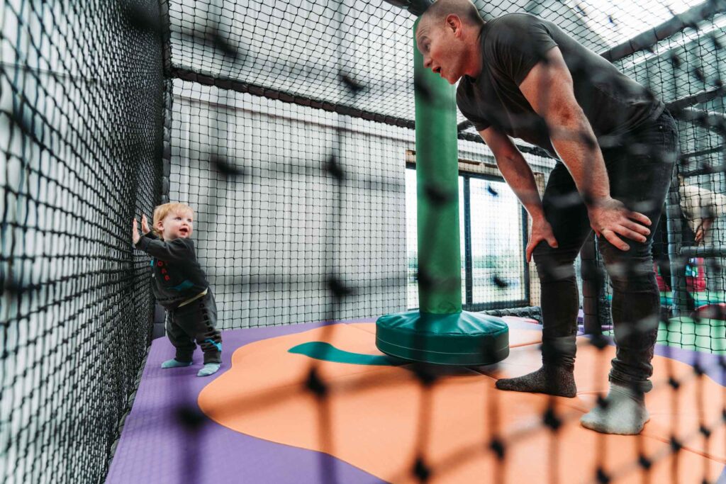 CHILDREN PLAYING IN A FARM THEMED INDOOR PLAY AREA